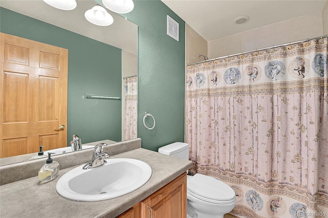 bathroom with a textured ceiling, toilet, a shower with shower curtain, and vanity