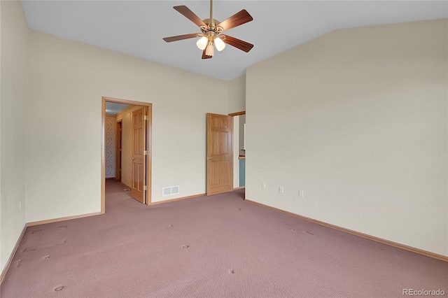 unfurnished bedroom featuring ceiling fan, connected bathroom, vaulted ceiling, and carpet floors