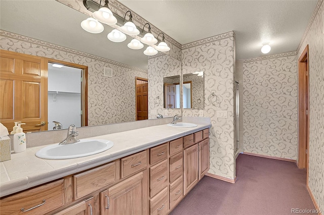 bathroom featuring vanity, a textured ceiling, and an enclosed shower