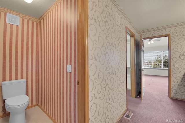 bathroom featuring a textured ceiling and toilet