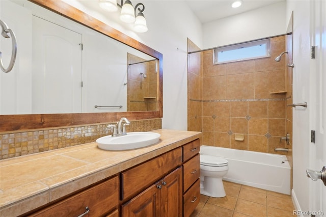 full bath featuring tasteful backsplash, tile patterned flooring, toilet, washtub / shower combination, and vanity