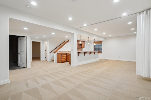 unfurnished living room with light colored carpet, stairs, recessed lighting, bar area, and baseboards