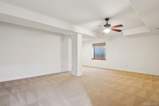 unfurnished room with light carpet, baseboards, and a ceiling fan