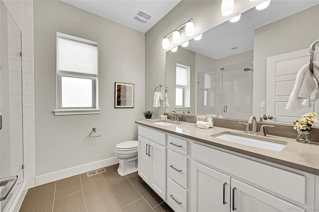 bathroom featuring a shower stall, visible vents, and a sink