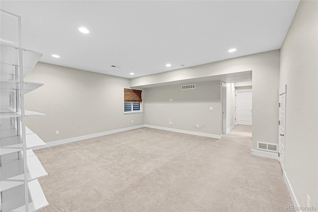 empty room with recessed lighting, visible vents, light carpet, and baseboards