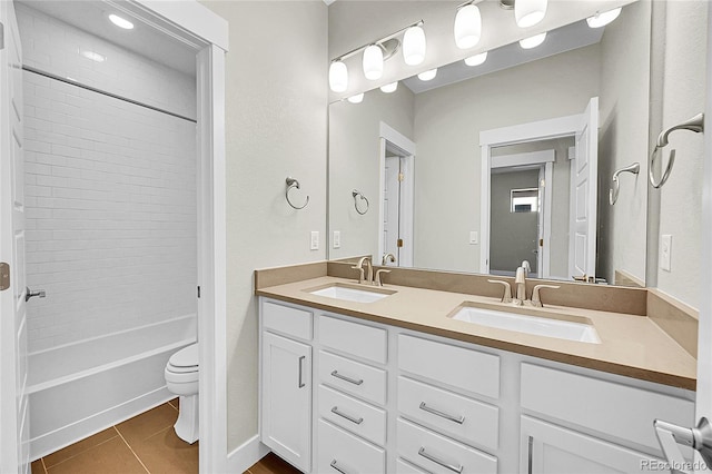 full bathroom with double vanity, bathtub / shower combination, tile patterned flooring, and a sink