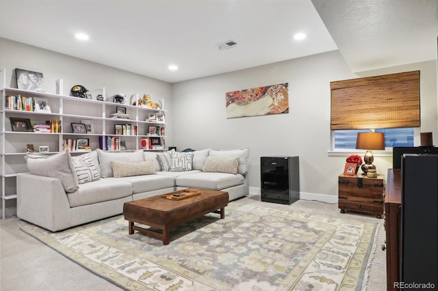 living room with recessed lighting, visible vents, light carpet, and baseboards