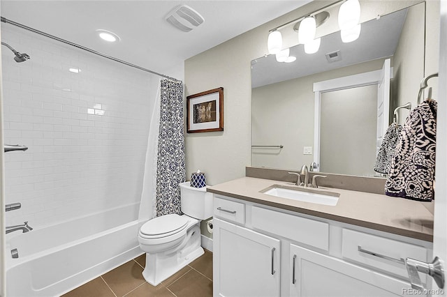 full bathroom featuring toilet, vanity, tile patterned flooring, and visible vents