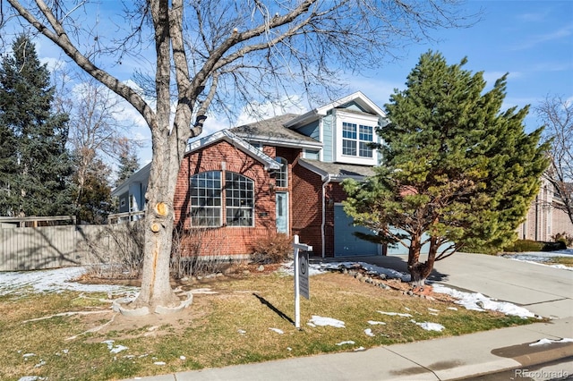 view of front of house featuring a garage and a front lawn