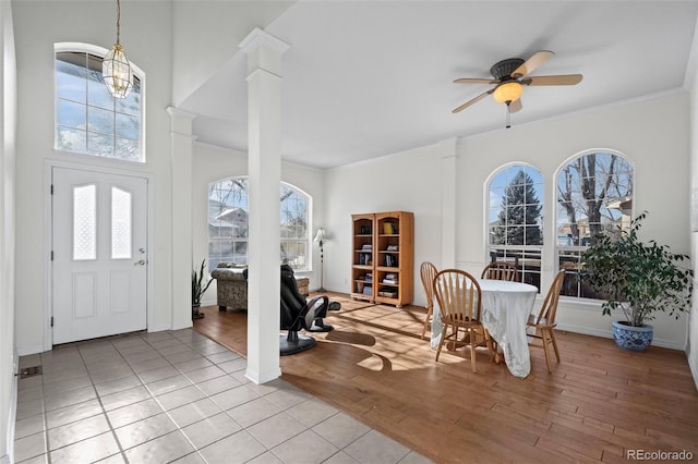 entryway featuring light hardwood / wood-style flooring, ornate columns, and ceiling fan