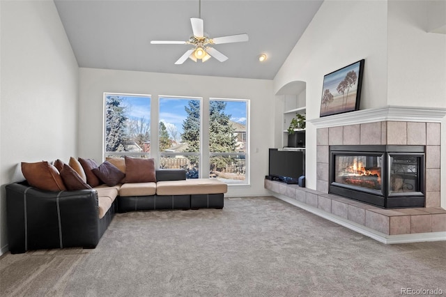 living room featuring ceiling fan, built in features, carpet, and vaulted ceiling