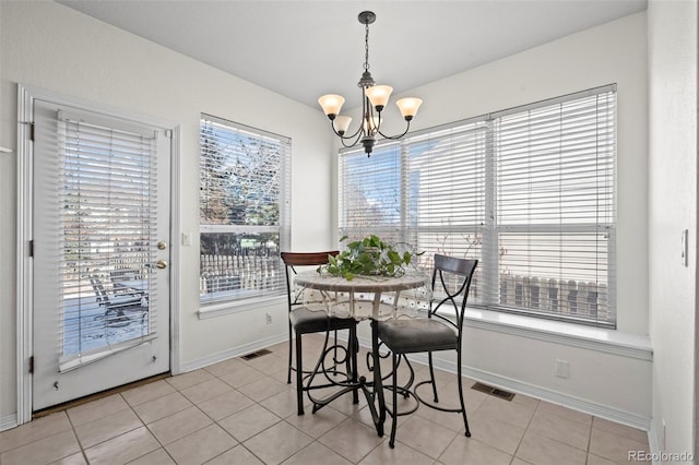 dining room with a notable chandelier and light tile patterned floors