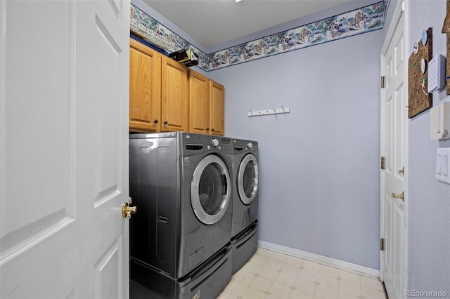 clothes washing area featuring cabinets and washing machine and dryer