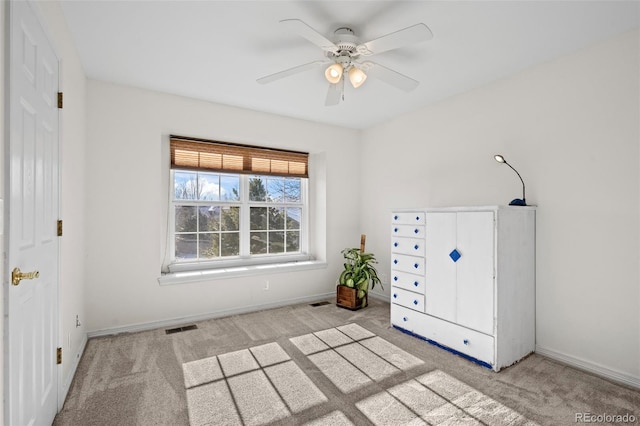 unfurnished bedroom with ceiling fan and light carpet