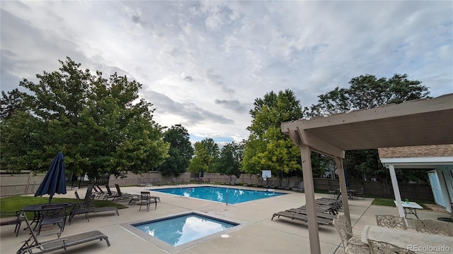 view of pool featuring a hot tub and a patio area