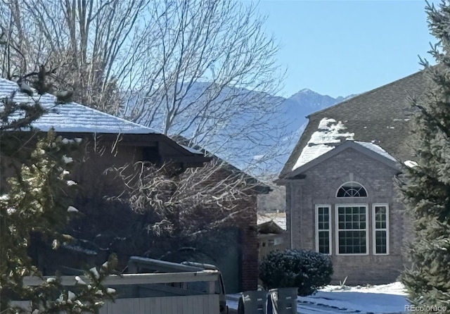 view of snow covered exterior featuring a mountain view