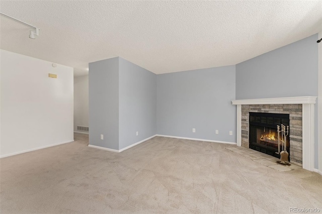 12573 E Pacific Cir Unit C, Aurora, CO 80014 - unfurnished living room featuring carpet, a glass covered fireplace, and a textured ceiling