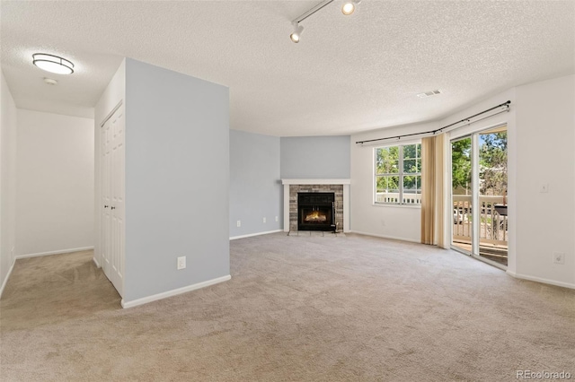 12573 E Pacific Cir Unit C, Aurora, CO 80014 - unfurnished living room featuring carpet, a textured ceiling, and a brick fireplace