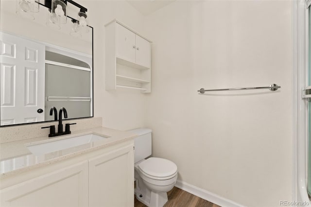 12573 E Pacific Cir Unit C, Aurora, CO 80014 - bathroom featuring vanity, wood finished floors, and an enclosed shower