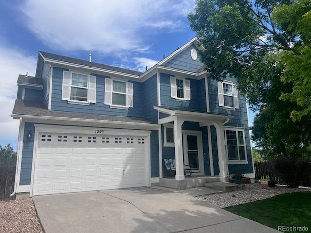 12491 E 106th Pl, Commerce City, CO 80022 - traditional home with concrete driveway, an attached garage, and a porch