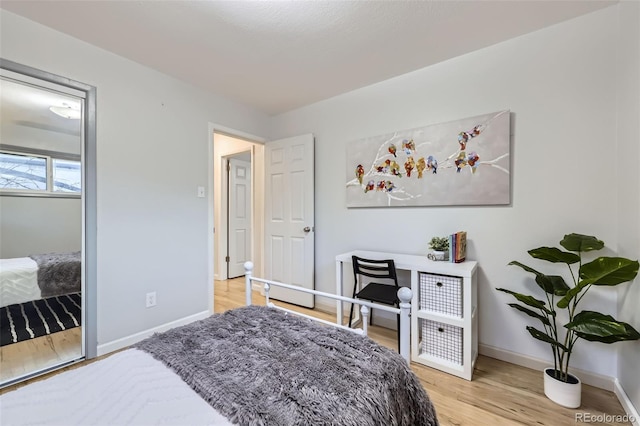 bedroom with baseboards and light wood-style floors