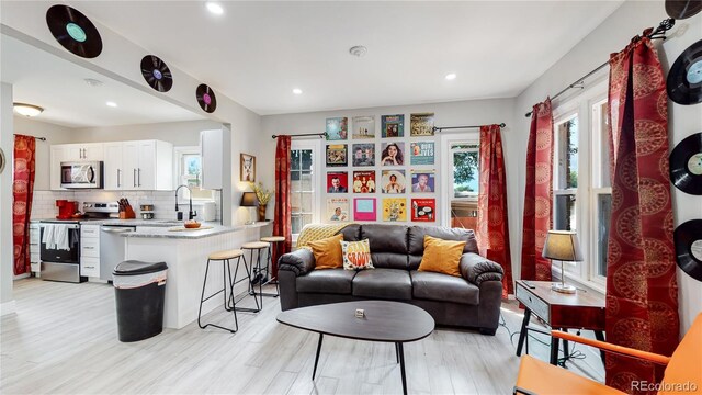 living room featuring light hardwood / wood-style flooring and sink