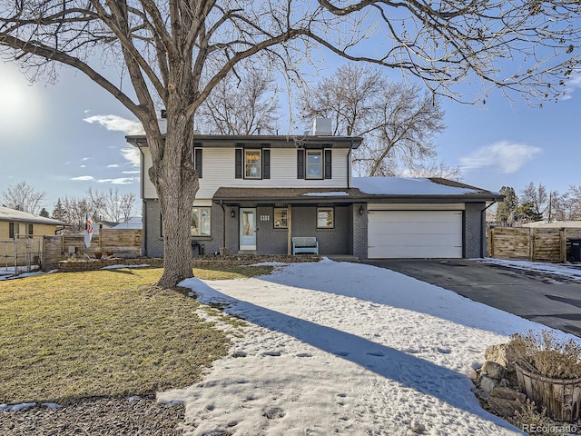 view of property with a garage and a front lawn