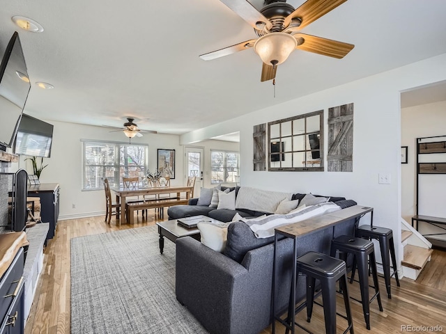 living room with hardwood / wood-style floors and ceiling fan