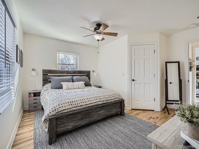 bedroom with ceiling fan and light wood-type flooring