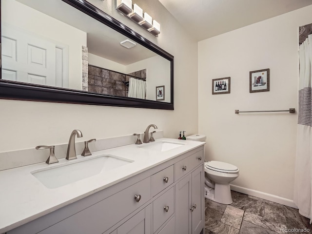 bathroom with vanity, toilet, and walk in shower