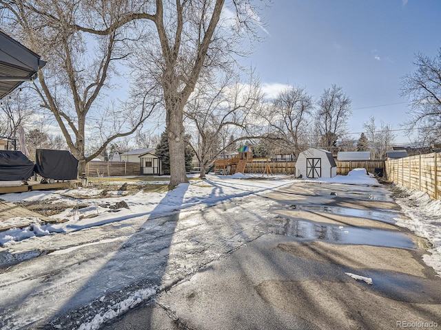 exterior space with a storage shed and a playground