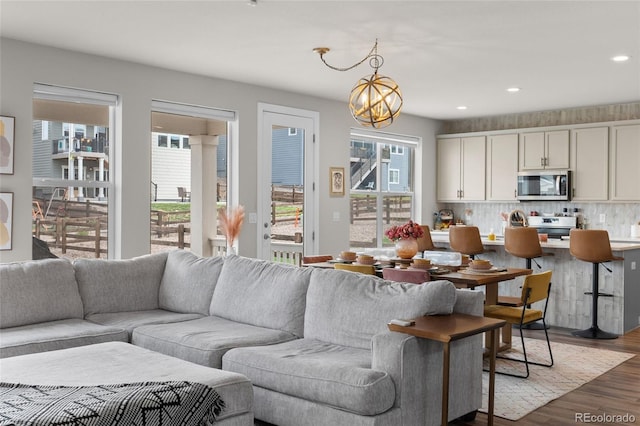 199 Simmental Loop, Castle Rock, CO 80104 - living area featuring plenty of natural light, wood finished floors, recessed lighting, and a chandelier