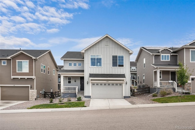 199 Simmental Loop, Castle Rock, CO 80104 - view of front of home featuring board and batten siding, covered porch, an attached garage, and driveway