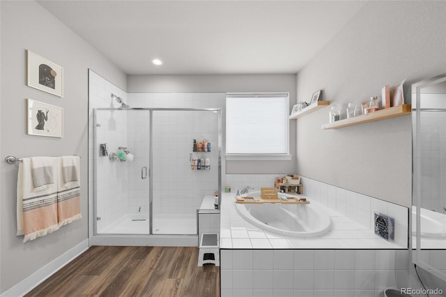 199 Simmental Loop, Castle Rock, CO 80104 - bathroom with a stall shower, wood finished floors, a bath, a sink, and baseboards