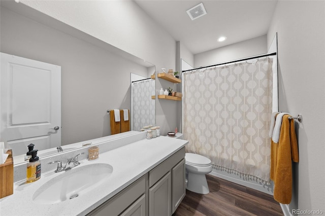 199 Simmental Loop, Castle Rock, CO 80104 - bathroom featuring vanity, toilet, wood finished floors, and shower / bathtub combination with curtain