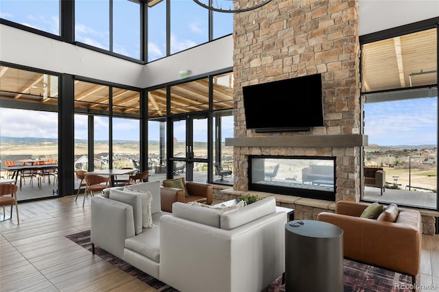 199 Simmental Loop, Castle Rock, CO 80104 - living room featuring a multi sided fireplace and a towering ceiling