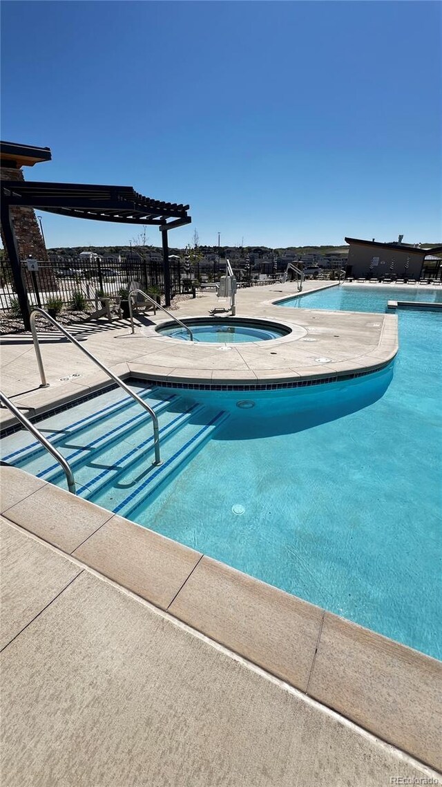 199 Simmental Loop, Castle Rock, CO 80104 - community pool with a community hot tub, a pergola, and a patio area