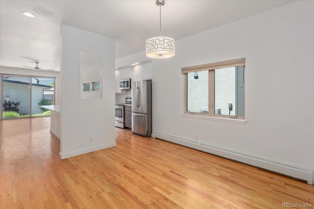 334 Old Stage Rd Unit B, Salida, CO 81201 - spare room featuring baseboard heating, light wood-style floors, and ceiling fan
