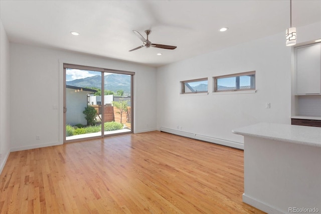 334 Old Stage Rd Unit B, Salida, CO 81201 - unfurnished living room with baseboard heating, light wood-style flooring, ceiling fan, and recessed lighting