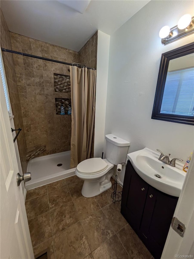 bathroom featuring visible vents, a shower stall, toilet, and vanity