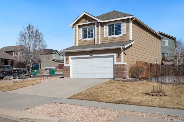 view of front of house with driveway, fence, roof with shingles, a garage, and brick siding