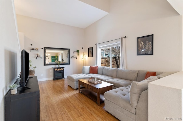 living room with light wood-type flooring and baseboards