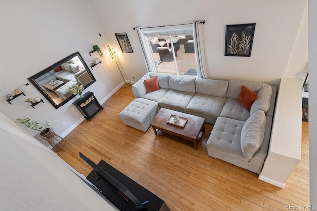 living area with wood finished floors and baseboards