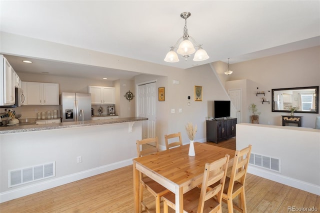 dining area featuring recessed lighting, baseboards, visible vents, and light wood-type flooring