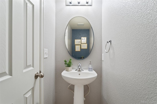 bathroom with a textured wall