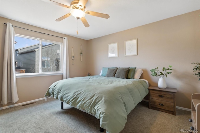 carpeted bedroom featuring visible vents, baseboards, and ceiling fan