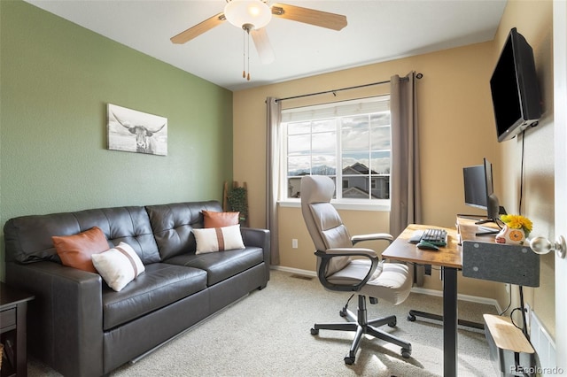 office space featuring carpet flooring, a ceiling fan, and baseboards