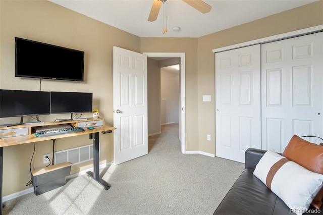 office space featuring baseboards, ceiling fan, and carpet floors