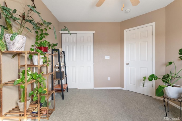 living area with carpet flooring, baseboards, and ceiling fan