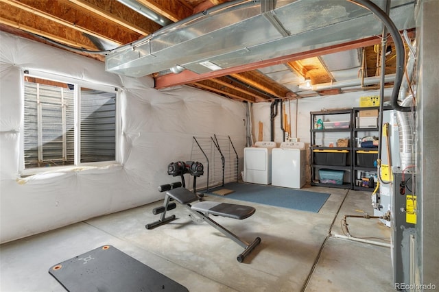 unfinished below grade area featuring independent washer and dryer